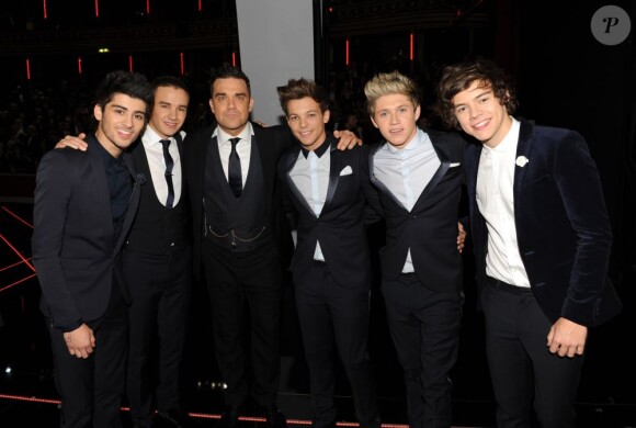 Les One Direction avec Robbie Williams, reçus par la reine Elizabeth II à Londres le 19 novembre 2012.