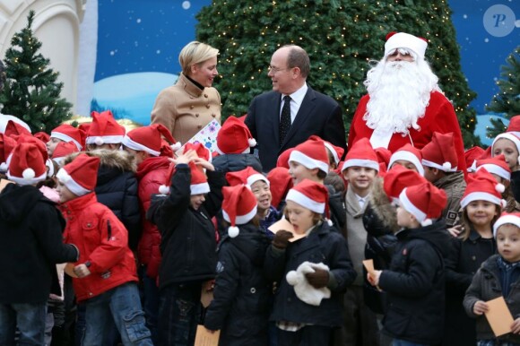 Charlene et Albert de Monaco ont posé avec les enfants, tous heureux, lors de la la traditionnelle fête de Noël au palais pour les enfants monégasques, le 12 décembre 2012.