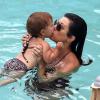 Kourtney Kardashian couvre sa fille Penelope de papouilles lors d'une baignade dans une piscine de l'hôtel Setai. Miami, le 21 juillet 2013.