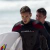Liam Payne et Louis Tomlinson du groupe One Direction apprennent à faire du surf sur une plage de Sydney, le 7 octobre 2013.