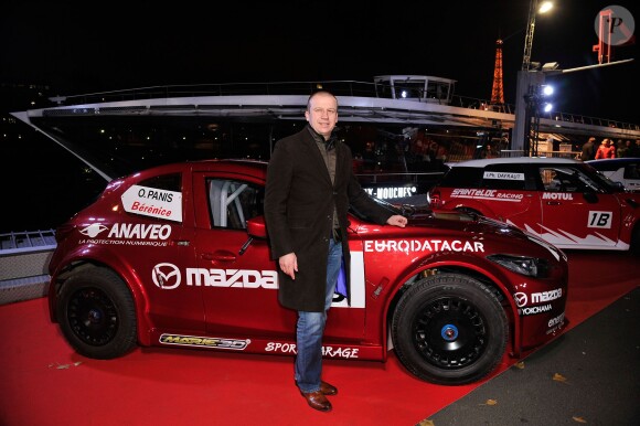 Olivier Panis pose devant sa voiture Mazda lors de la conférence de presse de la 25e édition du Trophée Andros à Paris le 27 novembre 2013.