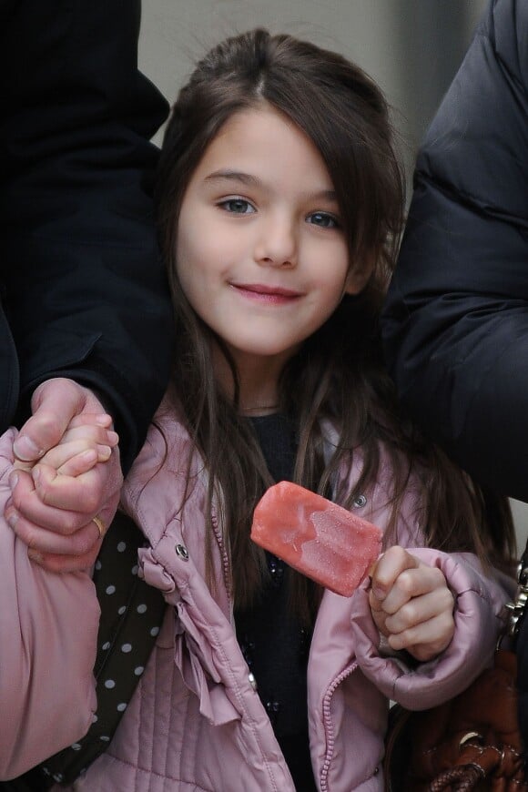 Please hide the child's face prior to the publication - Suri Cruise is spotted leaving the school eating an ice cream bar in New York City, NY, USA on December 11, 2013. Photo by Humberto Carreno/Startraks/ABACAPRESS.COM12/12/2013 - 
