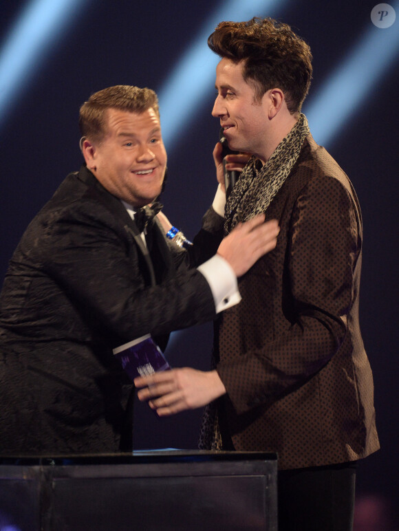 Nick Grimshaw et James Corden échangent un baiser sur la scène des BRIT Awards, à Londres, le 19 février 2014.