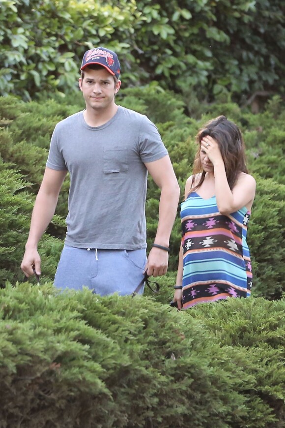 Exclusive. Expectant couple Ashton Kutcher and Mila Kunis took their two dogs out for a walk on a sunny afternoon in the Hollywood Hills, Los Angeles, CA, USA on May 1, 2014. Mila showed off her diamond engagement ring as well as a slight baby bump beneath her Southwest patterned dress. Ashton, who was dressed for a workout, kept a protective watch over his fiancee as they strolled through a residential neighborhood with their pets. Photo by GSI/ABACAPRESS.COM02/05/2014 - Los Angeles