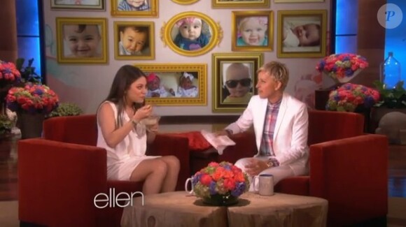 Mila Kunis, enceinte, mange sur le plateau d'Ellen DeGeneres (mai 2014).