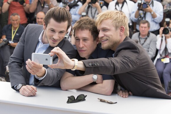 Gaspard Ulliel, Bertrand Bonello, Jérémie Renier - Photocall du film "Saint Laurent" lors du 67e festival international du film de Cannes, le 17 mai 2014.