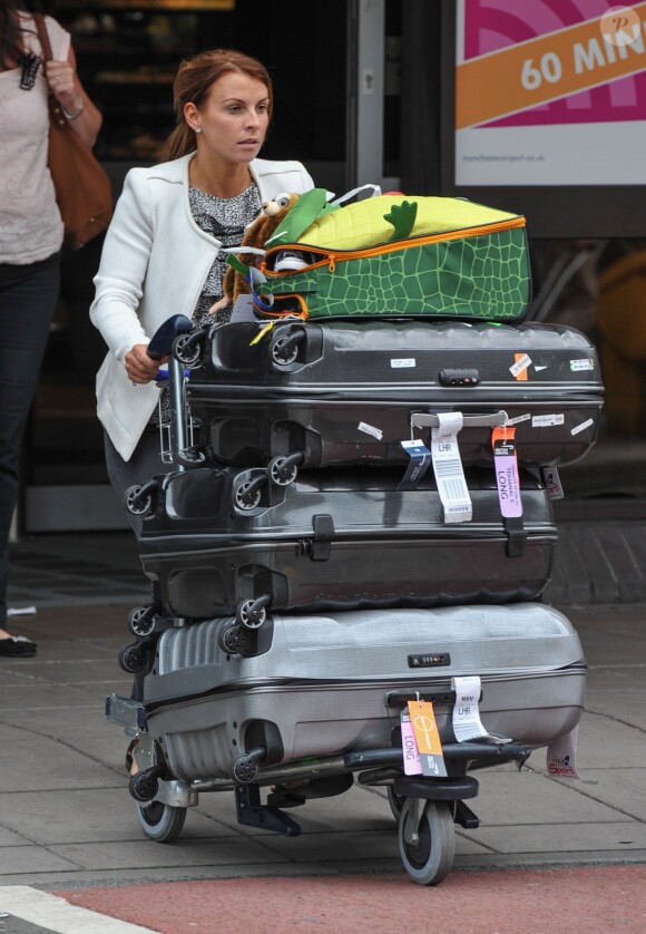 Please Hide The Child's Face Prior To The Publication - Coleen Rooney and family return home from brazil after watching wayne in the FIFA world cup in London, UK on June 25, 2014. Photo by XPosure/ABACAPRESS.COM25/06/2014 - 