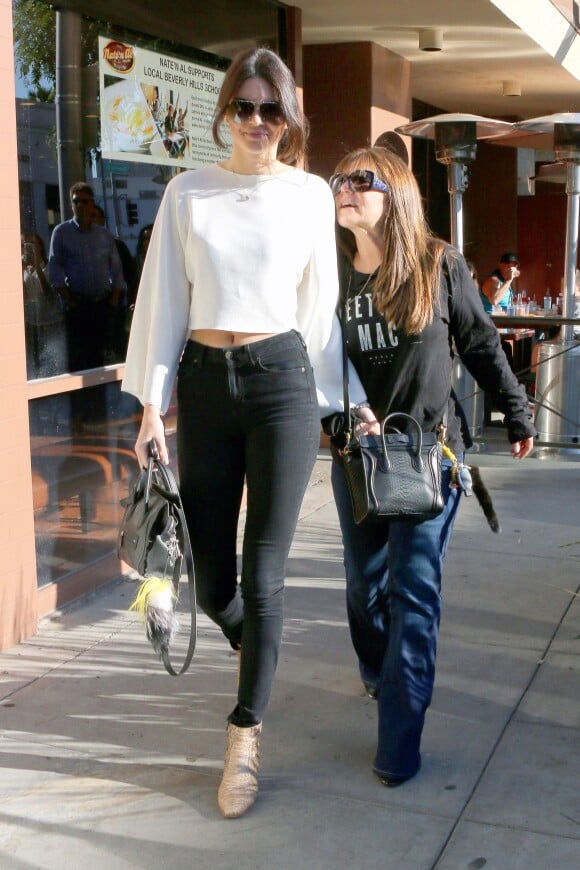 Kendall Jenner stops by Nate 'n Al Delicatessen again for lunch with a family friend in Los Angeles, CA, USA on December 06, 2014. The young model dined at the same restaurant yesterday where she met up with Kourtney Kardashian and Scott Disick. Kendall looked pretty in a white long sleeve top with skinny jeans and boots. Photo by GSI/ABACAPRESS.COM07/12/2014 - Los Angeles