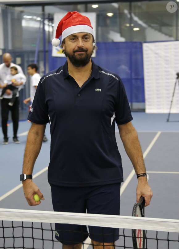Henri Leconte lors de la journée Sourire Gagnant organisée par l'association Enfant Star et Match au Levallois Sporting Club le 18 décembre 2014