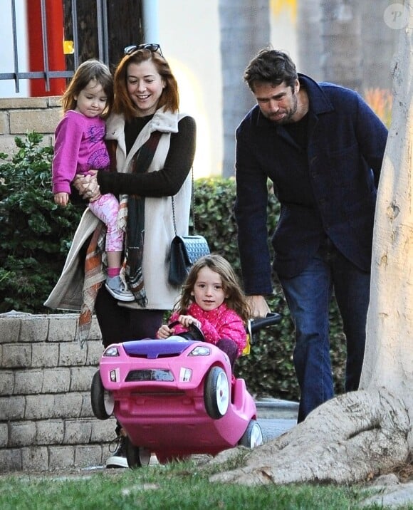 Exclusif - Alyson Hannigan et son mari Alexis Denisof se promènent avec leurs filles à Brentwood Los Angeles, le 27 décembre 2014  