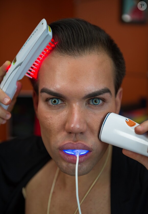 Brazilian-born Rodrigo Alves, 30, a trans-Atlantic flight attendant from London, UK who has spent over 120,000 euros on cosmetic surgery and treatments. A real life Ken Doll who has spent 120,000 euros on plastic surgery has vowed to go under the knife again - even though his obsession nearly killed him. Perfectionist Rodrigo Alves, 30, has splashed the cash on 12 operations since the age of 20, including nose jobs, liposuction, six-pack operations, calf shaping, pec implants, Botox fillers, and more. But Rodrigo's quest for perfection nearly cost him his life in January this year when a Brazilian doctor injected a gel into his arms to make them look more muscular. The flight attendant was struck down by a major infection which left him paralysed and unable to feed or wash himself. Photo by SWNS/ABACAPRESS.COM30/04/2014 - London
