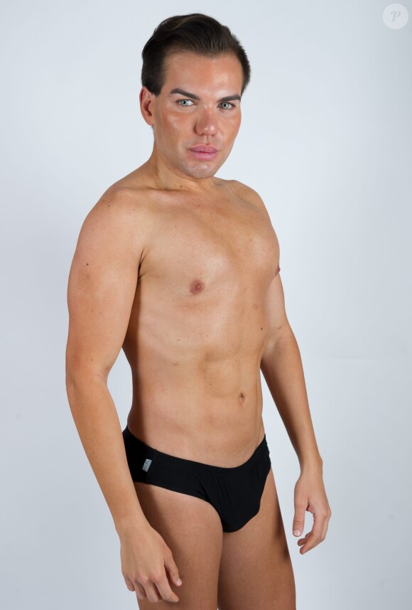 Brazilian-born Rodrigo Alves, 30, a trans-Atlantic flight attendant from London, UK who has spent over 120,000 euros on cosmetic surgery and treatments. A real life Ken Doll who has spent 120,000 euros on plastic surgery has vowed to go under the knife again - even though his obsession nearly killed him. Perfectionist Rodrigo Alves, 30, has splashed the cash on 12 operations since the age of 20, including nose jobs, liposuction, six-pack operations, calf shaping, pec implants, Botox fillers, and more. But Rodrigo's quest for perfection nearly cost him his life in January this year when a Brazilian doctor injected a gel into his arms to make them look more muscular. The flight attendant was struck down by a major infection which left him paralysed and unable to feed or wash himself. Photo by SWNS/ABACAPRESS.COM30/04/2014 - London