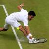 Novak Djokovic slides to make a shot against Roger Federer in the menÂ's singles final during day Thirteen of the Wimbledon Championships at the All England Lawn Tennis and Croquet Club in Wimbledon, UK on July 12, 2015. Photo by Jonathan Brady/PA Wire/ABACAPRESS.COM12/07/2015 - London