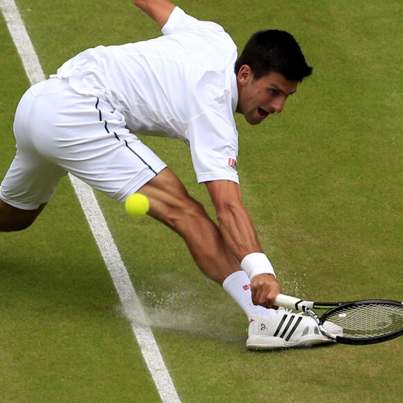Novak Djokovic slides to make a shot against Roger Federer in the menÂ's singles final during day Thirteen of the Wimbledon Championships at the All England Lawn Tennis and Croquet Club in Wimbledon, UK on July 12, 2015. Photo by Jonathan Brady/PA Wire/ABACAPRESS.COM12/07/2015 - London