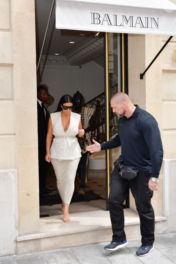 Kim Kardashian et son garde du corps Pascal Duvier quittent le magasin Balmain, rue François 1er. Paris, le 21 juillet 2015.