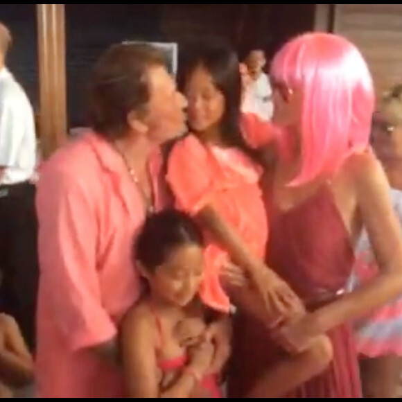Johnny et Laeticia Hallyday avec Jade et Joy devant leur gâteau d'anniversaire, tout rose. Ils avaient organisé le vendredi 7 août 2015 une fabuleuse Pink Party dans leur maison de Saint-Barthélemy pour fêter comme chaque année les anniversaires de leurs filles Jade (11 ans) et Joy (7 ans). Photo Instagram.