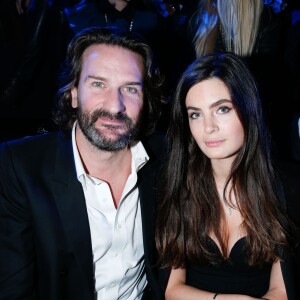 Frédéric Beigbeder et sa fiancée Lara Micheli - People au défilé de la collection Natalia pour Etam à la Bourse du Commerce à Paris, le 25 février 2014.  