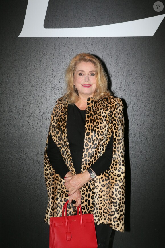 Catherine Deneuve et Gilles Dufour - People au défilé de mode "Saint Laurent", collection prêt-à-porter printemps-été 2016, à Carreau du Temple à Paris. Le 5 Octobre 2015