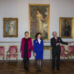 La princesse Victoria de Suède, enceinte de 7 mois, avec ses parents la reine Silvia et le roi Carl XVI Gustaf de Suède lors de l'inauguration de l'exposition Au fil du temps - 400 ans d'horloges royales, le 22 janvier 2016 au palais Drottningholm à Stockholm.