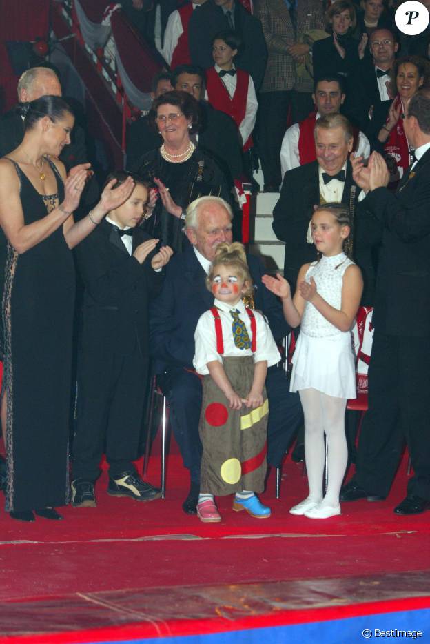 Le prince Rainier III de Monaco recevant un Clown d'or remis par Louis et Pauline Ducruet et Camille Gottlieb, les enfants de la pricnesse Stéphanie de Monaco, lors du 27e Festival international du cirque de Monte-Carlo en janvier 2003