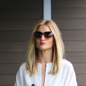Rosie Huntington-Whiteley à Los Angeles, porte une blouse blanche, un jean PAIGE®, une pochette en python Givenchy et des chaussures Gianvito Rossu (modèle Brooklyn). Le 9 juin 2016.