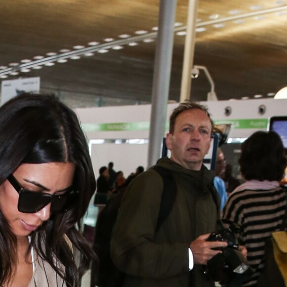 Kim Kardashian et Kanye West quittent Paris pour Los Angeles à l'aéroport de Roissy-Charles-de-Gaulle le 14 juin 2016.