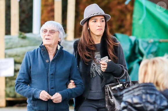 Exclusif - Bernie Ecclestone se promène avec sa femme Fabiana Flosi et des amis dans les rues de Gstaad pendant leurs vacances. Le 22 décembre 2014