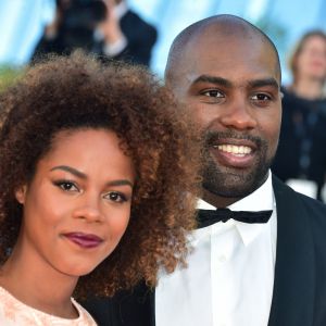 Teddy Riner et sa compagne Luthna lors de la montée des marches du film "Elle" lors du 69ème Festival International du Film de Cannes, le 21 mai 2016 à Cannes