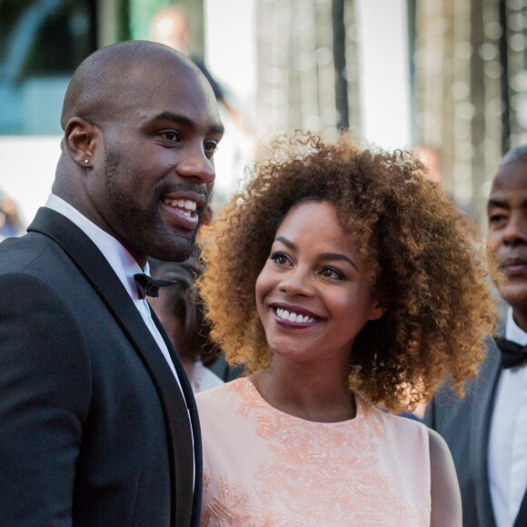 Teddy Riner et sa compagne Luthna lors de la montée des marches du film "Elle" lors du 69ème Festival International du Film de Cannes, le 21 mai 2016 à Cannes