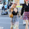 Rita Ora vue en pleine séance shopping sur Canal St à New York, habillée d'un body noir, d'une jupe transparente et de baskets adidas (modèle Superstar). Des lunettes vintage Chanel et un sac Miu Miu (modèle Dahlia) accessoirisent sa tenue. Le 7 août 2016.