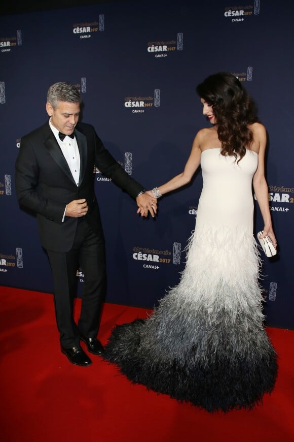 George Clooney (montre Omega) et sa femme Amal Alamuddin Clooney, enceinte et vêtue d'une robe Haute Couture Atelier Versace, assistent à la 42e cérémonie des César à la Salle Pleyel. Paris, le 24 février 2017. © Olivier Borde / Dominique Jacovides / Bestimage