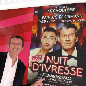 Jean-Luc Reichmann pose devant l'affiche du film "Nuit d'ivresse" à Paris le 9 janvier 2018