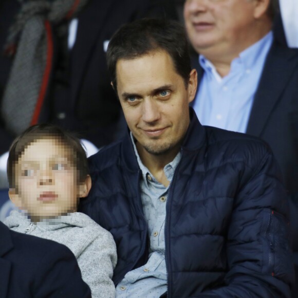 Grand Corps Malade (Fabien Marsaud) et son fils Yannis dans les tribunes du Parc des Princes lors du match de Ligue 1 PSG - Rennes à Paris, le 12 mai 2018, à l'issue duquel le Paris Saint-Germain a fêté son titre de champion de France.