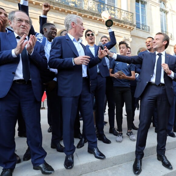 Corentin Tolisso, Noël Le Graët , Didier Deschamps, Raphaël Varane, Olivier Giroud, Emmanuel Macron, Djibril Sidibé, Nabil Fékir, Florian Thauvin - Le président de la République Française E. Macron et la Première dame B. Macron, accueillent les joueurs de l'équipe de France (Les Bleus) et son sélectionneur D. Deschamps, le président de la Fédération Française de Football N. Le Graët et des membres de la FFF, dans les jardins du Palais de l'Elysée à Paris, le 16 juillet 2018. L'équipe de France a été sacrée Championne du Monde 2018, pour la deuxième fois de son histoire, après sa victoire en finale face à la Croatie (4-2) © Sébastien Valiela/Bestimage