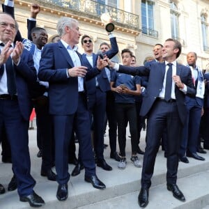 Corentin Tolisso, Noël Le Graët , Didier Deschamps, Raphaël Varane, Olivier Giroud, Emmanuel Macron, Djibril Sidibé, Nabil Fékir, Florian Thauvin - Le président de la République Française E. Macron et la Première dame B. Macron, accueillent les joueurs de l'équipe de France (Les Bleus) et son sélectionneur D. Deschamps, le président de la Fédération Française de Football N. Le Graët et des membres de la FFF, dans les jardins du Palais de l'Elysée à Paris, le 16 juillet 2018. L'équipe de France a été sacrée Championne du Monde 2018, pour la deuxième fois de son histoire, après sa victoire en finale face à la Croatie (4-2) © Sébastien Valiela/Bestimage