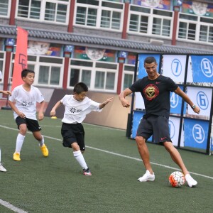 (180719) -- BEIJING, July 19, 2018 (Xinhua) -- Portuguese football player Cristiano Ronaldo plays football with students as he attends a promotional event in Beijing, China, on July 19, 2018. Photo by Xinhua/Cao Can/Newscom/ABACAPRESS.COM19/07/2018 - Beijing