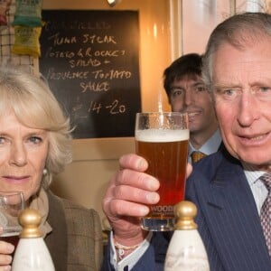 Le prince Charles et Camilla Parker Bowles, duchesse de Cornouailles, dégustant une pinte de bière dans un pub à Purleigh le 29 janvier 2014.