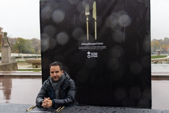 Action contre la Faim dénonce l'utilisation de la faim comme arme de guerre avec sa campagne internationale #StopHungerCrime avec l'ambassadeur de l'opération Christophe Michalak, sur la place du Trocadéro à Paris, France, le 12 novembre 2018. Action contre la Faim a dressé une immense table de 15m nappée de noir. Les passants seront conviés à s'assoir sur l'unique chaise posée face aux couverts (fabriqués à partir de douilles de balles, non utilisées et confisquées en zone de conflit) et découvrir l'origine de leurs histoires. © Pierre Perusseau/Bestimage