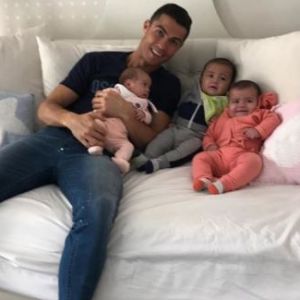 Cristiano Ronaldo "retenu prisonnier" par ses trois bébés, Alana Martina et les jumeaux Eva et Mateo, dans une photo partagée sur Instagram le 26 décembre 2017.