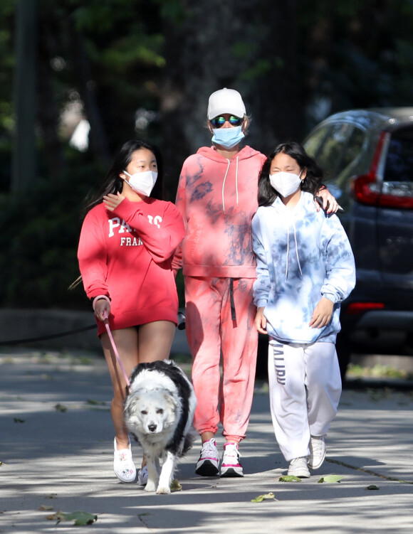 Laeticia Hallyday, ses filles Jade et Joy, avec des masques, se promènent dans le quartier de Pacific Palisades, à Los Angeles, Californie, Etats-Unis, le 3 avril 2020.