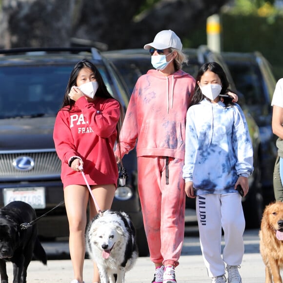 Christina arrive en fin d'après-midi chez Laeticia avec son chien Bono et des masques de protection à la main. Laeticia Hallyday, ses filles Jade et Joy, Christina, avec des masques, et leurs chiens Santos, Cheyenne et Bono se promènent dans le quartier de Pacific Palisades, à Los Angeles, Californie, Etats-Unis, le 3 avril 2020, pendant la période de confinement. Jade et Joy s'amusent avec leurs masques pendant la balade.