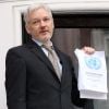Julian Assange, le créateur de Wikileaks lors d'une conférence de presse d'un balcon à l'ambassade d'Equateur à Londres, le 5 février 2016. Julian Assange brandit le rapport en sa faveur du comité de travail de l'ONU sur la détention arbitraire.