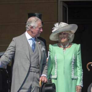 Camilla Parker Bowles, duchesse de Cornouailles, le prince Harry, duc de Sussex, et Meghan Markle, duchesse de Sussex, lors de la garden party pour les 70 ans du prince Charles au palais de Buckingham à Londres. Le 22 mai 2018