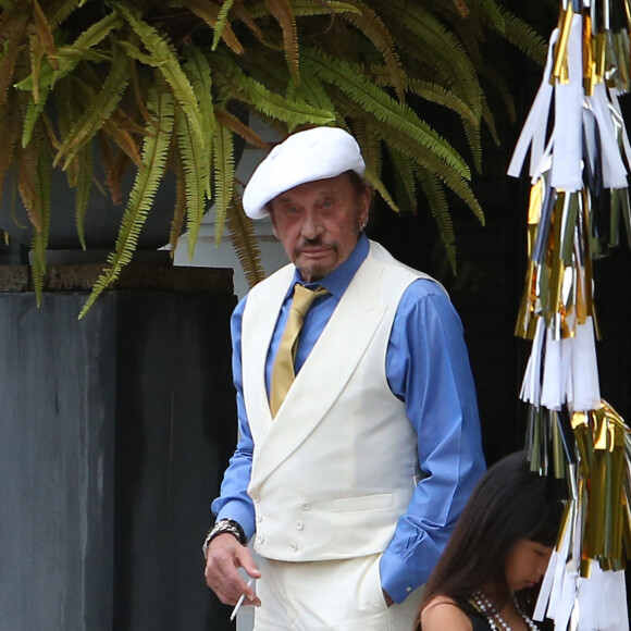Exclusif - PRIX SPECIAL - No Web - Johnny Hallyday habillé en Gatsby le Magnifique et sa fille Joy nous saluent depuis sa maison de Pacific Palissade le 13 juin 2015.