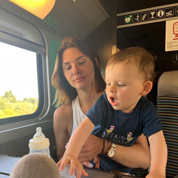 Camille Lacourt, sa compagne Alice et son fils Marius dans le train.