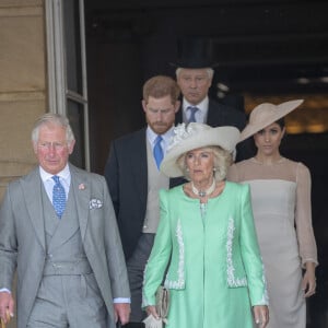 Camilla Parker Bowles, duchesse de Cornouailles, le prince Harry, duc de Sussex, et Meghan Markle, duchesse de Sussex, lors de la garden party pour les 70 ans du prince Charles au palais de Buckingham à Londres. Le 22 mai 2018 