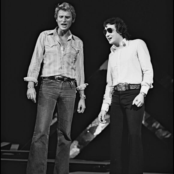 Archives - Johnny Hallyday et Michel Sardou sur le plateau de l'émission de TF1 "Numero 1 à Michel Sardou" en 1975.