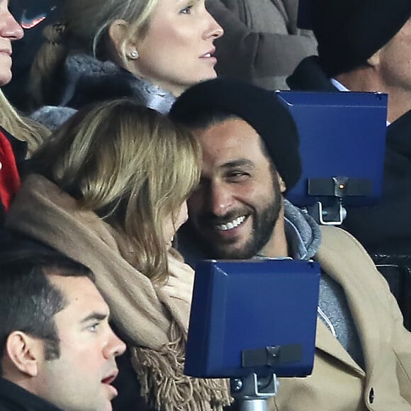 Maxim Nucci et sa compagne Isabelle Ithurburu enceinte assistent au huitième de finale retour de Ligue des Champion, du Paris Saint-Germain contre le Real Madrid au Parc des Princes à Paris le 6 mars 2018. © Cyril Moreau/Bestimage