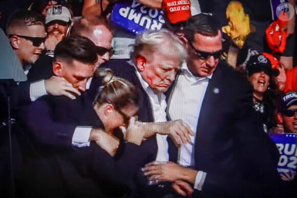 July 14, 2024, Butler, Pennsylvania, United States: In this photo illustration, a screen shows Former US President Donald Trump shot in the ear at a rally he was holding in Butler. Former US President Donald Trump was wounded in a shooting at a rally he was holding in Butler, Pennsylvania as part of his election campaign ahead of the 2024 US Presidential election. According to the latest reports, secret agents killed a shooter and one rally participant died at the hands of the shooter himself, the shooting at the rally is being investigated as an attempted assassination of former President Trump, the Associated Press reports, citing the Butler County District Attorney. (© Artem Priakhin/SOPA Images via ZUMA Press/Bestimage 