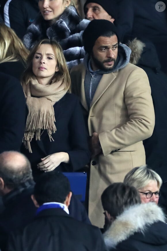 Maxim Nucci et sa compagne Isabelle Ithurburu enceinte assistent au huitième de finale retour de Ligue des Champion, du Paris Saint-Germain contre le Real Madrid au Parc des Princes à Paris le 6 mars 2018. © Cyril Moreau/Bestimage